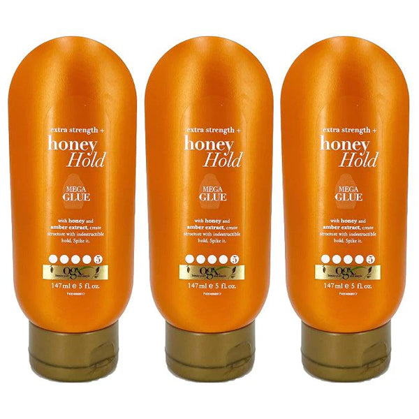 Three bottles of OGX Extra Strength Honey Hold Mega Glue, 5 ounces each, stand upright on a white background—ideal for all-day, unbeatable hold. Available in 3 or 6 packs.